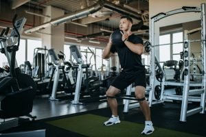 Man doing exercises, using balls and exercise tape.